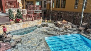 A pool area with stone flooring, a fire pit, and outdoor seating. - Cozy Mountain Getaway by InvitedHome | Walk to Ski, Hot Tub, Village Center (Vail)