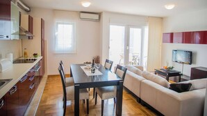 Une cuisine moderne avec un coin repas, un canapé et un téléviseur.