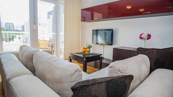 Apartment, Balcony, Sea View | Living room | 100-cm TV with satellite channels