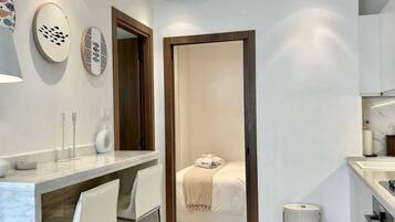 A modern bathroom with a shower, toilet, and sink.
