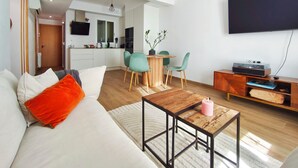 A modern living room with a sofa, a coffee table, and a TV. - 2 bedrooms. Roman Amphitheater. Near the beach (Tarragona)