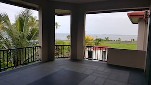 A balcony with a view of the sea and palm trees. - Seaview Drive, Executive Home (Sigatoka)