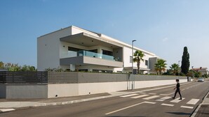 Un bâtiment moderne doté d’un toit plat, de grandes fenêtres et d’un balcon.