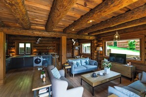 A rustic cabin interior with a kitchen, living area, and a large window. - ✨ Chalet Harmony – 9 Guests – Hot Tub – Close to Gérardmer (Liézey)