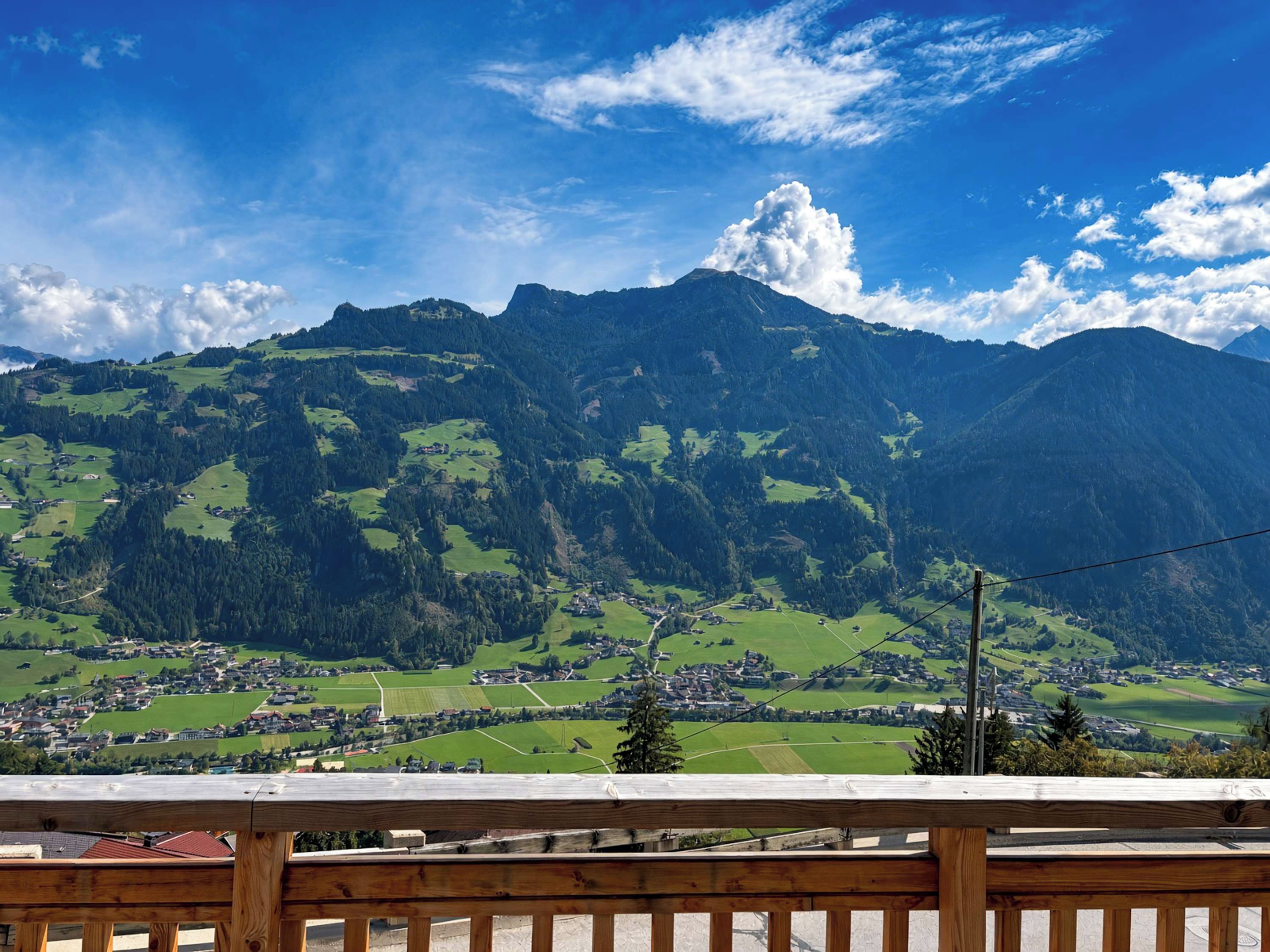 A mountain landscape with a town in the valley below.