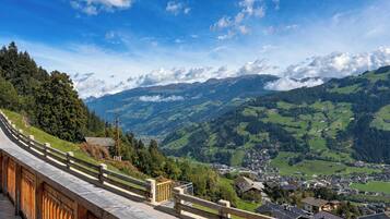 A scenic mountain view with a wooden walkway overlooking a valley.