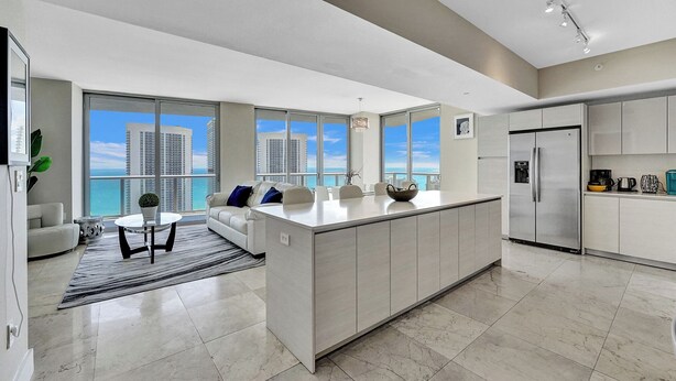 A modern kitchen with a large island, stainless steel appliances, and a view of the ocean. - Spacious 3-bedroom apartment Ocean View in lovely Hallandale Beach (Hallandale Beach)