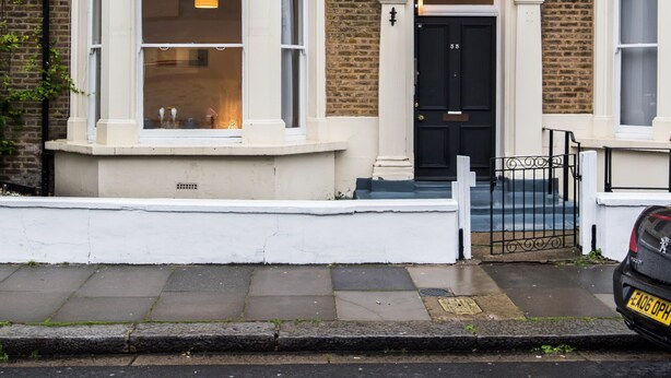 A two-story brick house with bay windows, a black front door, and a small front garden. - Hammersmith Stayz (London)