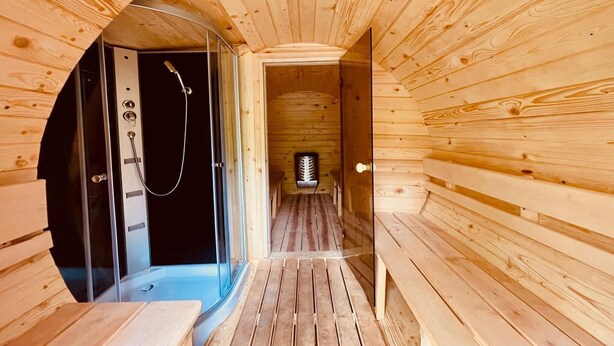 A wooden sauna with a glass door, a bench, and a sauna room visible through the door. - Double room, sauna, Masuria (Ruciane Nida)