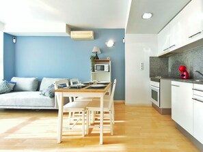 A modern kitchen with white cabinets, a microwave, and a red kettle. - Apartment 5 min. from the beach Palamós Costa Brava (Palamós)