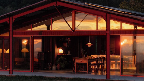 A modern building with large glass windows, a dining area with tables and chairs, and a visible kitchen area. - Architect's house (Vollore-Montagne)