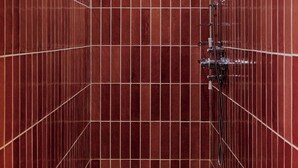 A tiled shower stall with a handheld showerhead and a handheld shower attachment. - Architect's house (Vollore-Montagne)