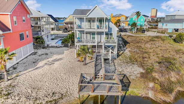 A coastal property with a multi-story house, a beach, and a waterway. - 🌞🐠Waterfront | Walk to the Beach | Community Boat Launch | Happy Daze (Gulf Shores)
