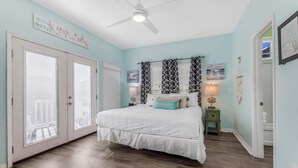 A bedroom with a bed, a ceiling fan, a nightstand, and a window with blinds. - 🌞🐠Waterfront | Walk to the Beach | Community Boat Launch | Happy Daze (Gulf Shores)