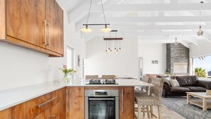 A modern kitchen with wooden cabinets, a built-in oven, and pendant lighting. - Shelley Point 36 on 20th Street (St. Helena Bay)