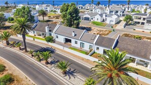 A coastal residential area with modern houses, a road, and palm trees. - Shelley Point 36 on 20th Street (St. Helena Bay)