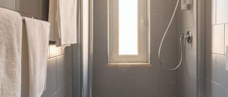 Habitación básica doble | Baño | Regadera, toallas, papel de baño