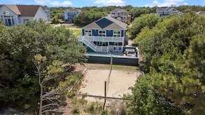 A residential area with houses, a swimming pool, and a fenced yard. - Whalehead Retreat w/ Pool, Hot Tub, 5min to Beach (Currituck County)