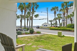 A view of a hotel entrance with palm trees, a golf cart, and a clear sky. - ⭐Across from Beach | Beach View from Patio | 2 Pools | Maravilla 3108⭐ (Miramar Beach)