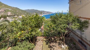 A balcony with a view of a coastal landscape, including a beach and mountains. - 'Fabian's House' with Sea View in Taormina (Taormina)