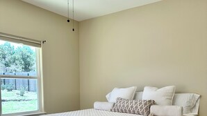 A bedroom with a bed, a ceiling fan, and a window. - 3-bedroom house in pleasant Fischer with big secluded backyard (Fischer)