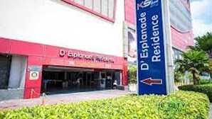 Ein Gebäude mit einem Schild, auf dem 'D'Esplanade Residence' steht, und einem Pfeil.