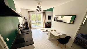 A compact kitchen with a dining area, a small table, and a sofa. - Beautiful 54 m² apartment with parking in Nantes (Nantes)