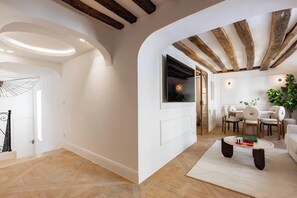 A modern interior with a dining area, a living space, and a staircase. - JUST STEPS AWAY FROM THE ICONIC NOTRE DAME -RUE SAINT-SÉVERIN (Paris)