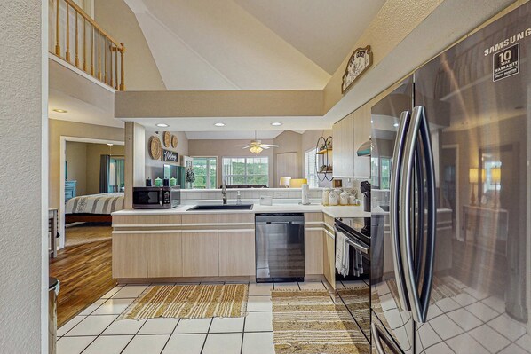 A modern kitchen with a stainless steel refrigerator, a dishwasher, and a microwave. - GOLF VIEWS - Spacious 3BR Condo with Loft & Pool (Branson)