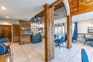 A café interior with wooden beams, a chalkboard menu, and blue chairs. - Bold 2BR Condo - PET-FRIENDLY - Loft in Branson (Branson)