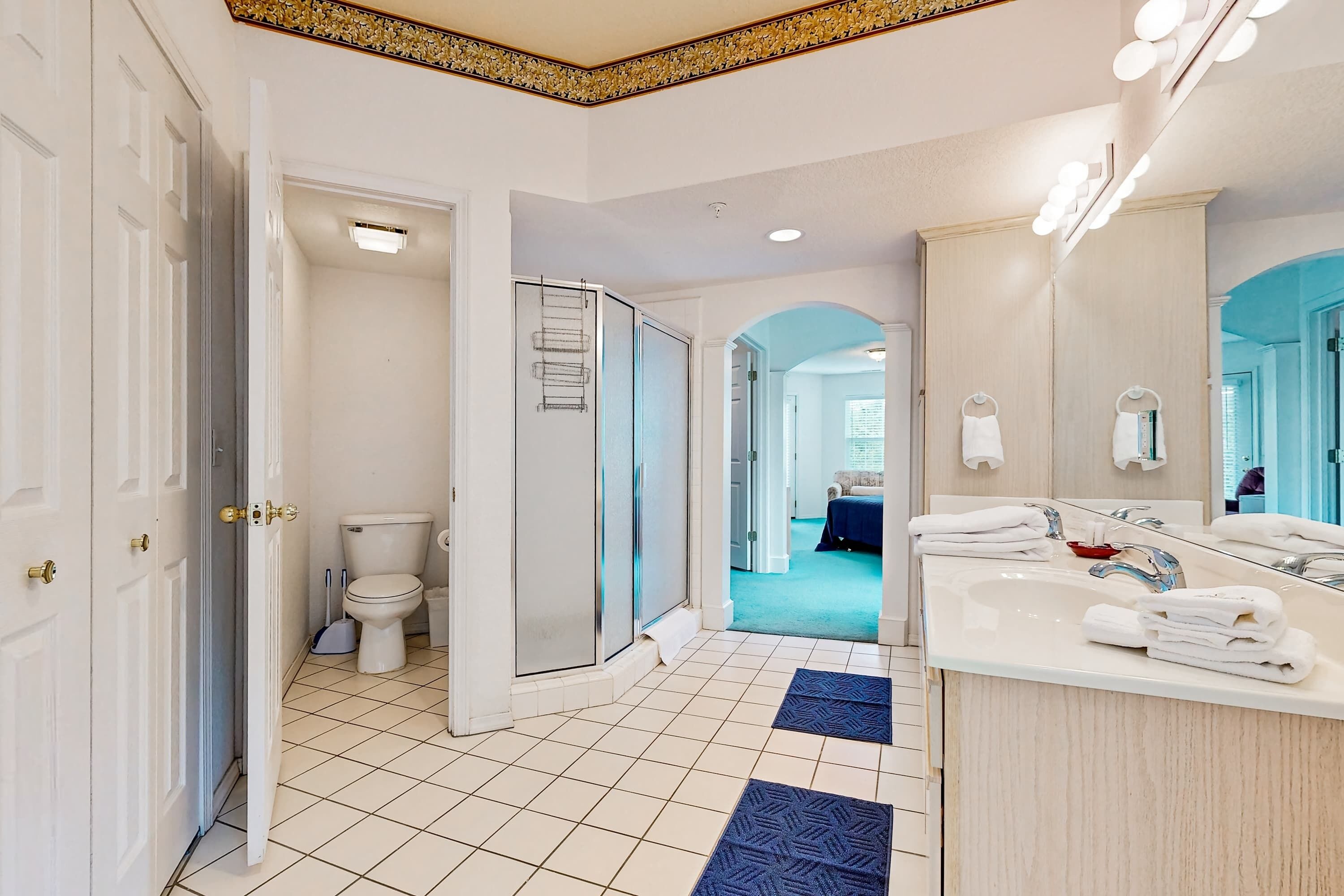 A modern bathroom with a toilet, shower, and sink.