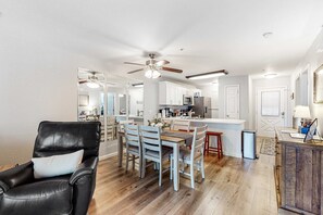 A modern kitchen with white cabinets, a central island, and a ceiling fan. - Comfy 2BR Condo - FIREPLACE - Sleeps 6 Branson (Branson)