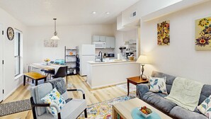 A modern apartment with a kitchen, dining area, and living room. - Rustic 2BR Cabin *POOL* Wooded (Kimberling City)