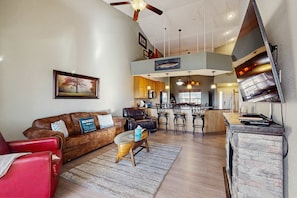 A spacious living area with a sofa, a coffee table, and a fireplace. - LAKE VIEW 3BR Condo - Pool & Entertainment Ready (Branson)