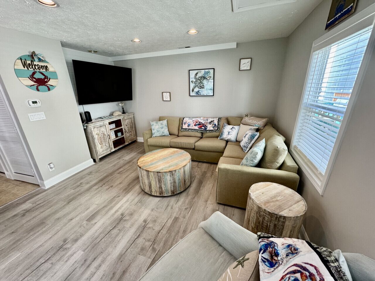 A living room with a sofa, coffee table, and a TV.