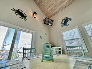 A dining area with a table, chairs, and a decorative crab wall art piece. - Ocean lakes-Free golf cart-Ocean View (Myrtle Beach)