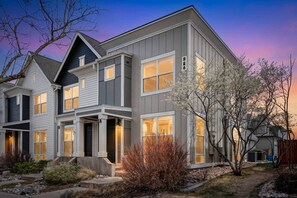 A multi-story residential building with a modern design, featuring a prominent entrance and large windows. - Brand New Build with Hot Tub that Sleeps 8 in Central Fort Collins! (Fort Collins)