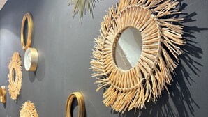 A wall with various circular mirrors and decorative items.
