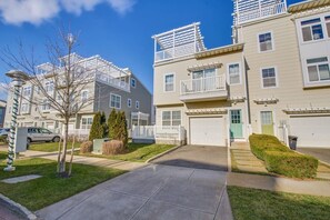 Un edificio residencial con garaje, entrada cubierta y césped cuidado.