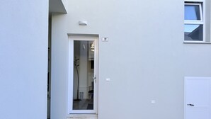 A white door with a small window, a number '9' sign, and a light fixture above it. - B002 - Bellaria, large apartment close to the sea (Bellaria)
