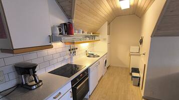 Comfort Apartment, 2 Bedrooms, Balcony, Courtyard View | Private kitchen | Dining tables