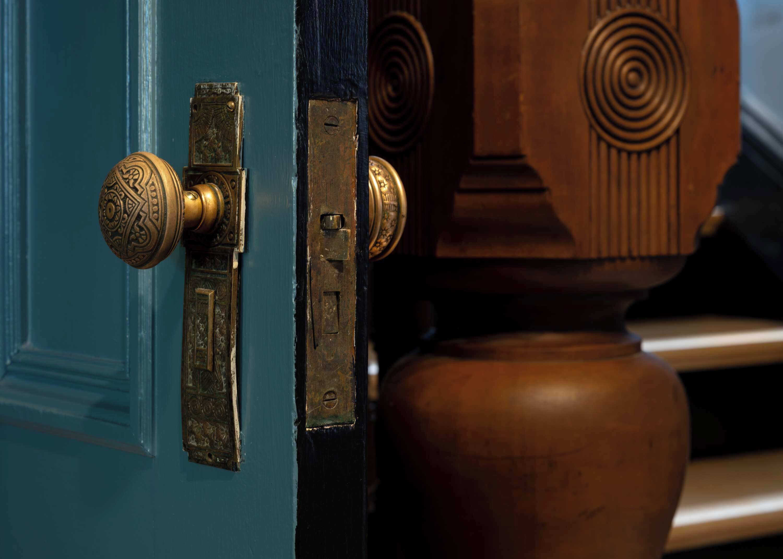 A door with a brass handle and a latch.