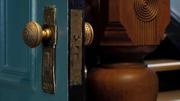A door with a brass handle and a latch.