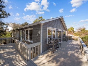 A house with a deck, a covered patio, and a large window. - AfterDune Shade-Dog-Friendly & Private, gated beach parking (Emerald Isle)