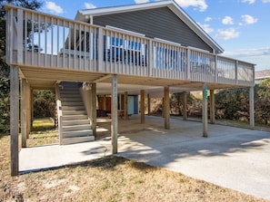 A two-story house with a covered patio, a staircase, and a driveway. - AfterDune Shade-Dog-Friendly & Private, gated beach parking (Emerald Isle)