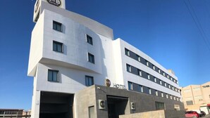 A modern B&B hotel with a flat facade, multiple windows, and a prominent entrance.