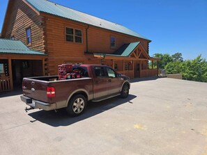 A wooden cabin with a truck parked in front. - Sleeps 40 | 12BR, Indoor Pool, 2 Hot Tubs (Pigeon Forge)