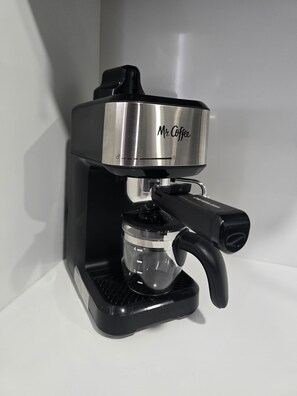 A coffee machine with a transparent water reservoir and a black handle. - Miami Health District 1/1 w/2Gbps WiFi Stainless Steel 75” & 55” TV Pet friendly (Miami)