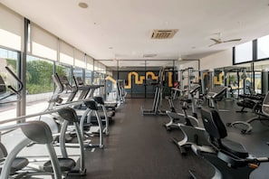 A gym with treadmills, elliptical machines, and weight equipment.