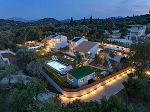 A modern villa with a swimming pool, multiple bedrooms, and a well-maintained garden.